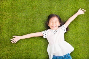 young girl on turf lawn