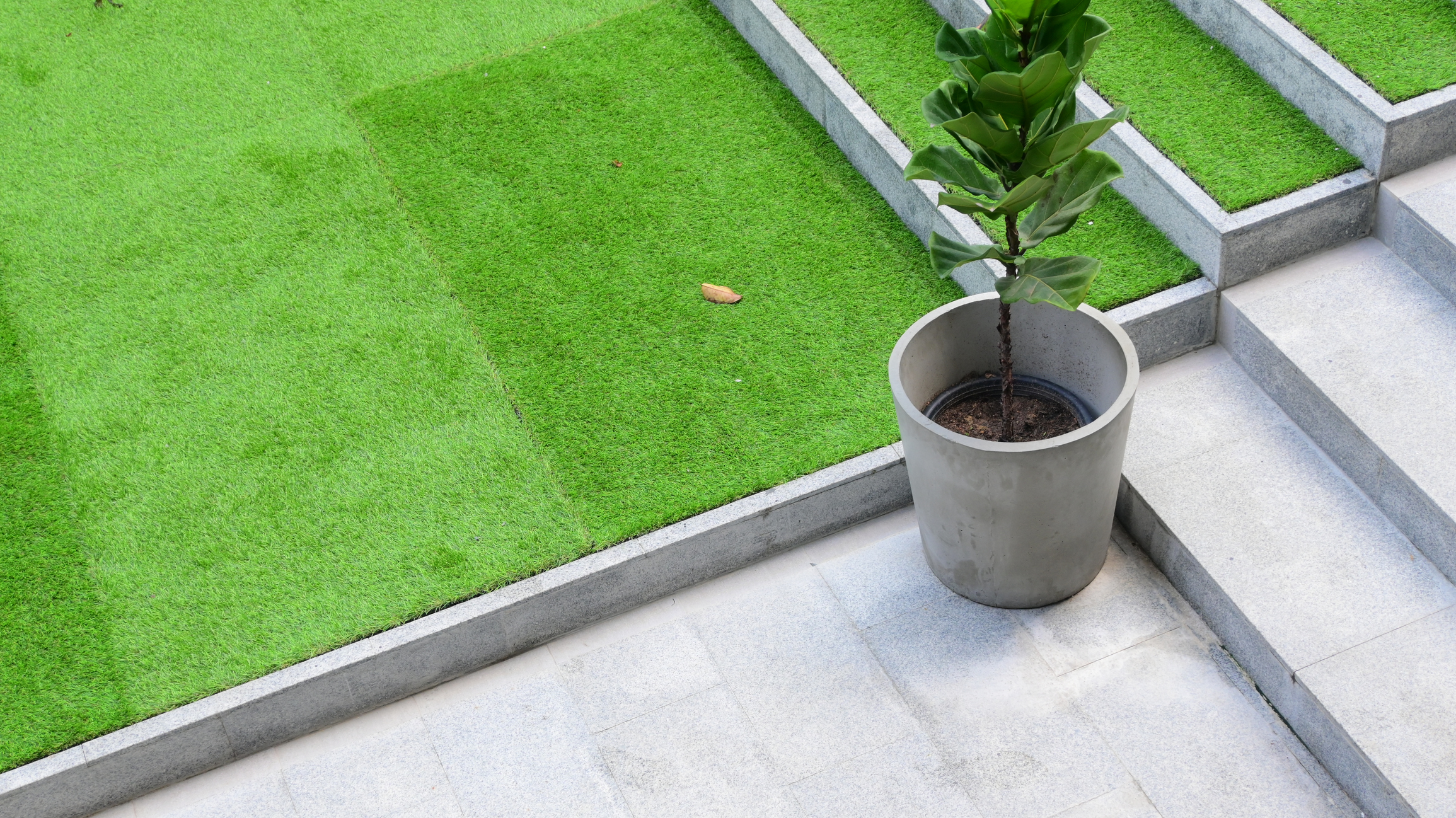 Artificial green grass on a modern home's exterior staircase for DC-area-homeowners-are-switching-to-artificial-turf blog.